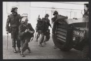 Soldiers take shelter from flying stones behind an armed car, Londonberry, Northern Ireland