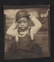 [Photo booth portrait of a young boy]
