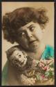[Crying girl holding doll]