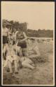 [Double exposure of group on beach]