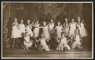 [Group of girls in costumes on stage]