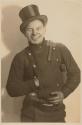 [Smiling man wearing a top hat]