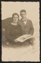 [Woman and boy holding album]