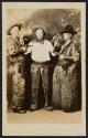 [Three men in cowboy clothing]