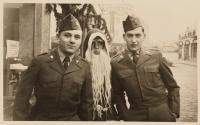 [Two young men with costumed figure]
