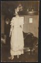 [Woman in dress, facing away from camera]
