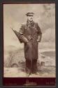 [Man standing with umbrella in pocket]
