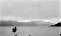 Two figures in row boat--mountains in background, Japan Trip