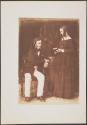[Seated man and standing woman]