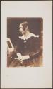 [Woman seated in profile]