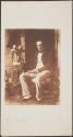 [Man seated in chair]