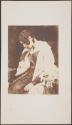 [Seated young woman in fringed shawl]
