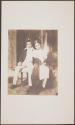 [Boy and girl, seated]