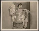 [Woman in shiny dress with fan]