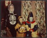 [Three children in Halloween costumes]