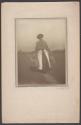 [Woman walking away, carrying two jugs at side]