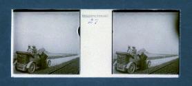 [Two women and driver, castle on distant island]
