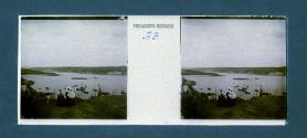 [Two woman with child on hill over looking lake]