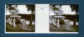 [Woman and two men next to car on roadside]