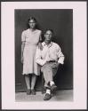 Couple, man seated