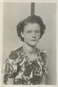 [Woman in glasses wearing floral dress]