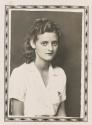 [Curly haired woman; diamond border]
