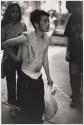 [Young, shirtless man holding plastic bag]