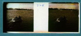 [Two people and dog in small boat]
