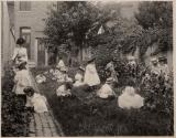 [Children and teacher in a garden]