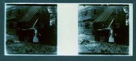 [Woman next to house under construction]