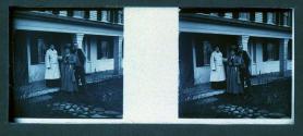 [Two women, one man on porch]