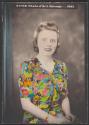 [Woman in colorful print dress]