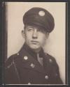 [Soldier with ribbon on lapel and chain on shoulder]