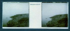 [View of men on hilltop overlooking water]