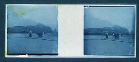 [Woman and child posing in front of bridge]