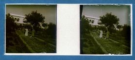 [Two unid. men wearing bathrobes standing in garden]