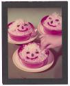 [Three face cakes]