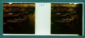 [Man standing in boat at dock]