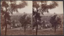 [View overlooking cemetery, with houses in the background]