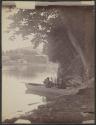 [Two people in a canoe on river]