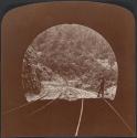 [Person at entrance of railroad tunnel]