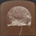 [Person at entrance of railroad tunnel]
