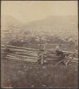 [Man sitting on fence looking towards the Narrows and Cumberland, MD]