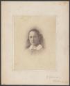 [Young woman with hair bow]