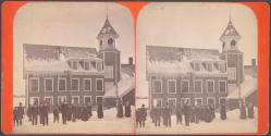 [Group of people by building in winter]
