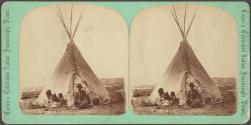 [Seated Native woman, children and man in western hat in front of tipi]