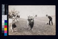 [John Robert Taylor photographing a group of women dancers in costume]