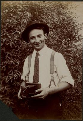 [Man holding camera]