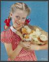[Girl with straw hat full of chicks (American Cyanamid)]