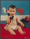 [Baby playing with a toy phone (Cream of Wheat)]